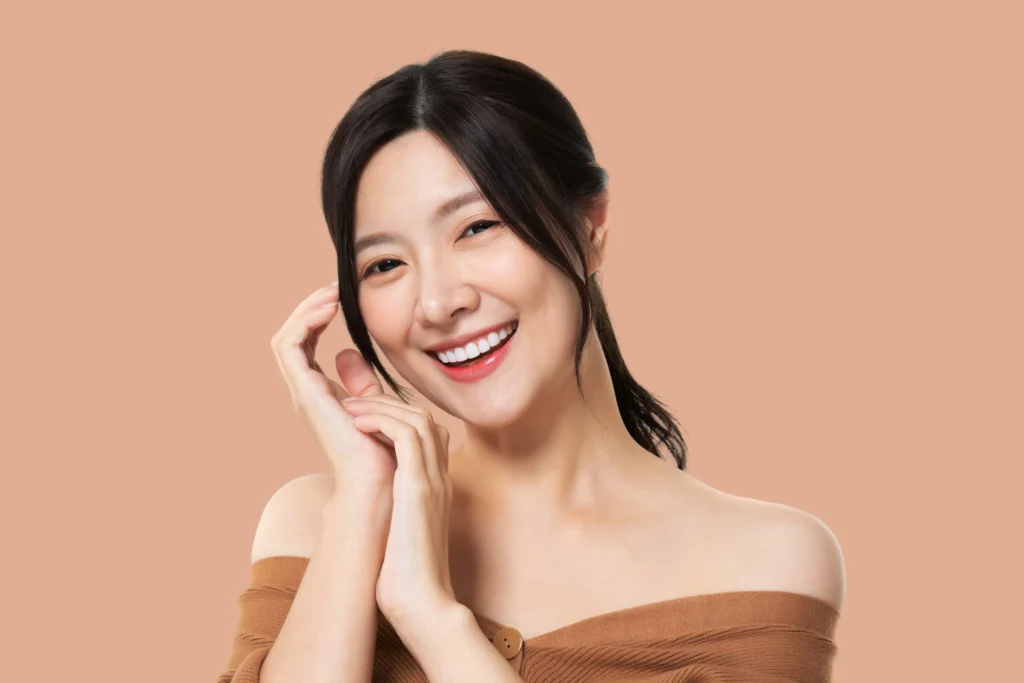 beautiful model girl with perfect fresh clean skin youth skin care concept isolated pastel brown background Horizontal