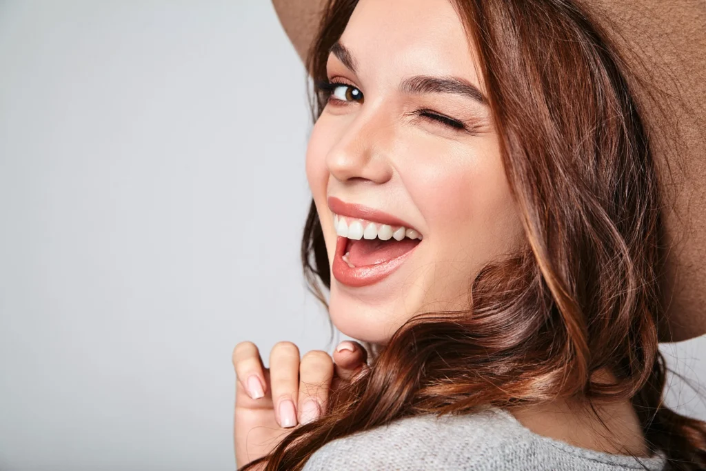 portrait young stylish laughing model gray casual summer clothes brown hat with natural makeup Horizontal